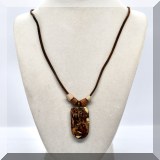 J103. Leather cord necklace with bone pendant. Signed Thommy. - $30 